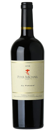Red wine bottle with 'Peter Michael' label on a white background