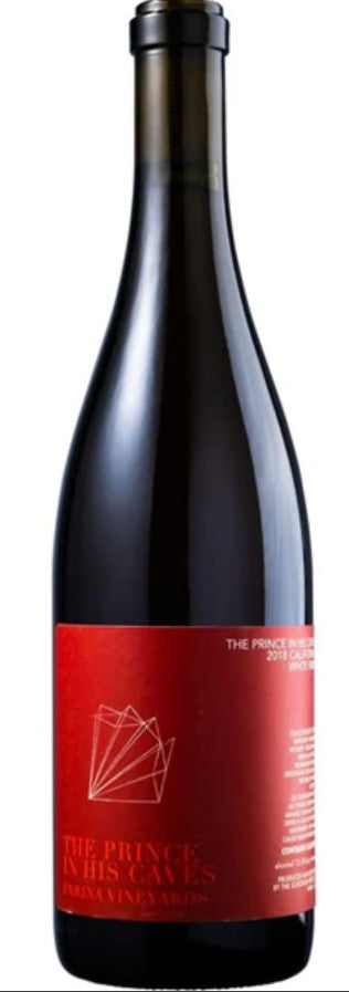 Red wine bottle with a red label on a black background