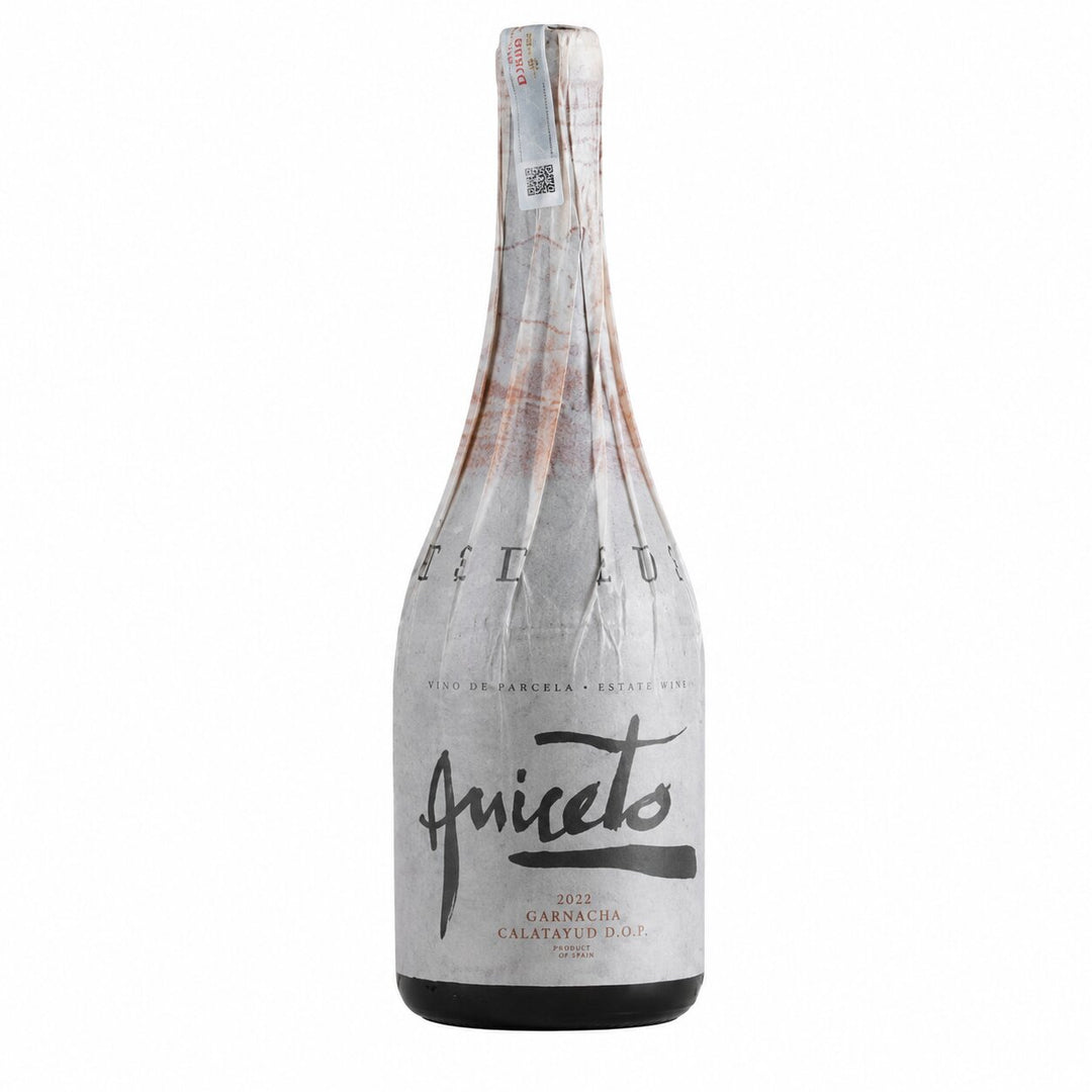A bottle of Aniceto Garnacha Calatavedo dry white wine, wrapped in a textured silver foil sleeve with black script branding, set against a plain white background.