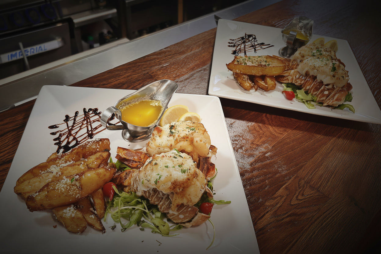 Two plates of food on a wooden table with kitchen equipment in the background