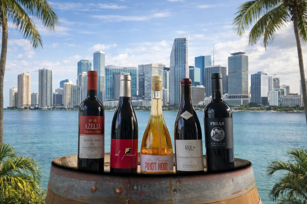 Five wine bottles on a barrel with a city skyline and water in the background