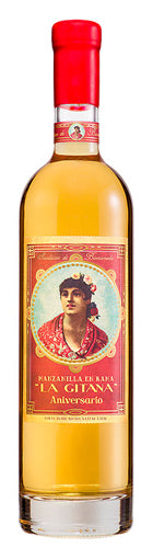 Bottle of La Gitanilla Aniversario rum with a red cap and label featuring an illustration.